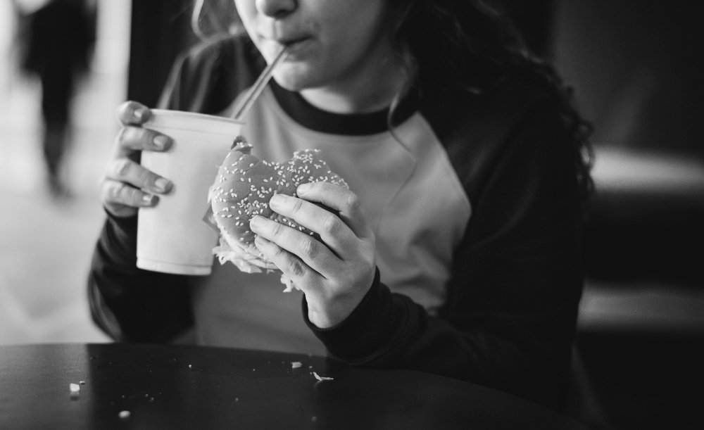teenage-girl-eating-hamburger